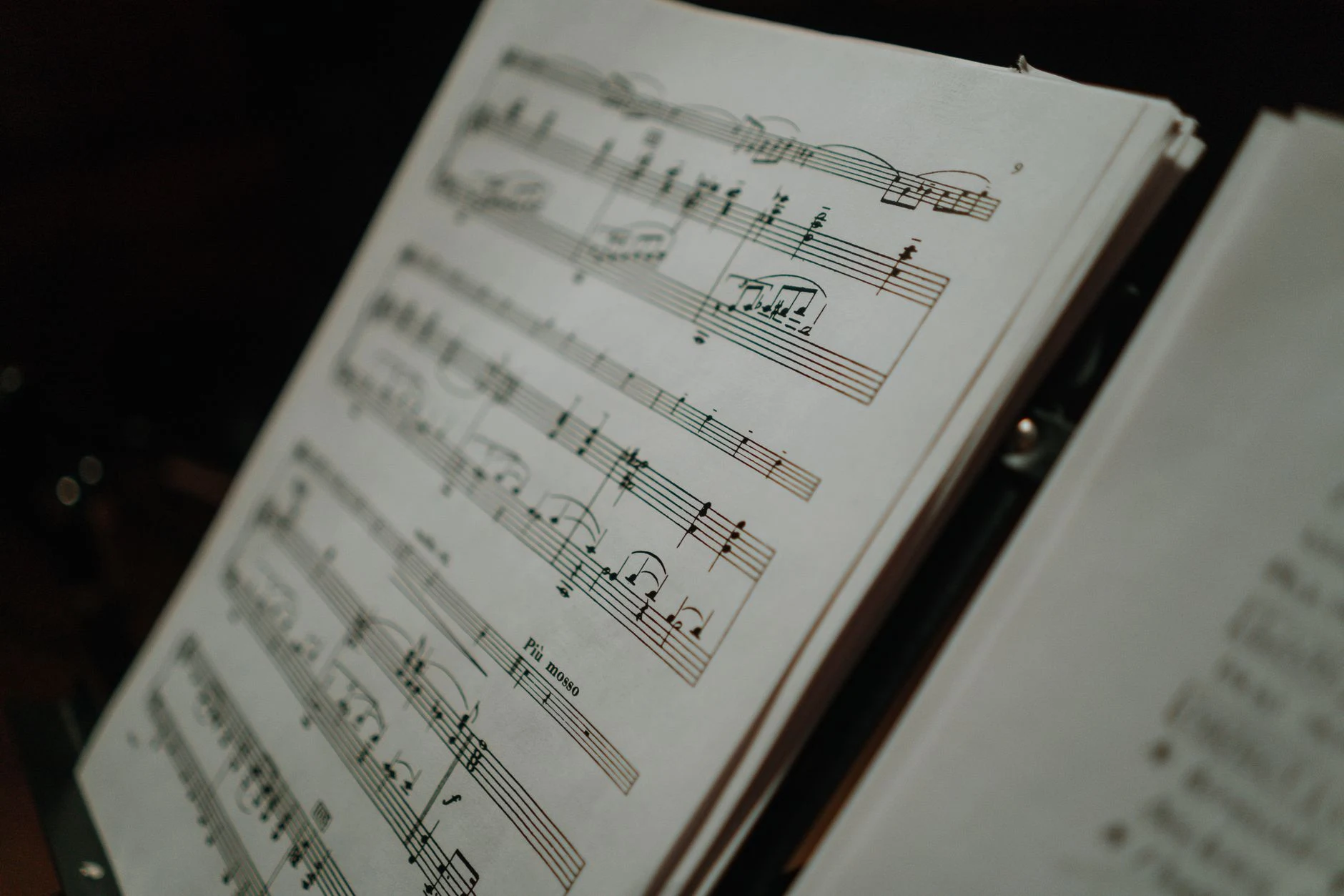 Close-up of sheet music displaying musical notes on a stand, perfect for musical compositions and practice.