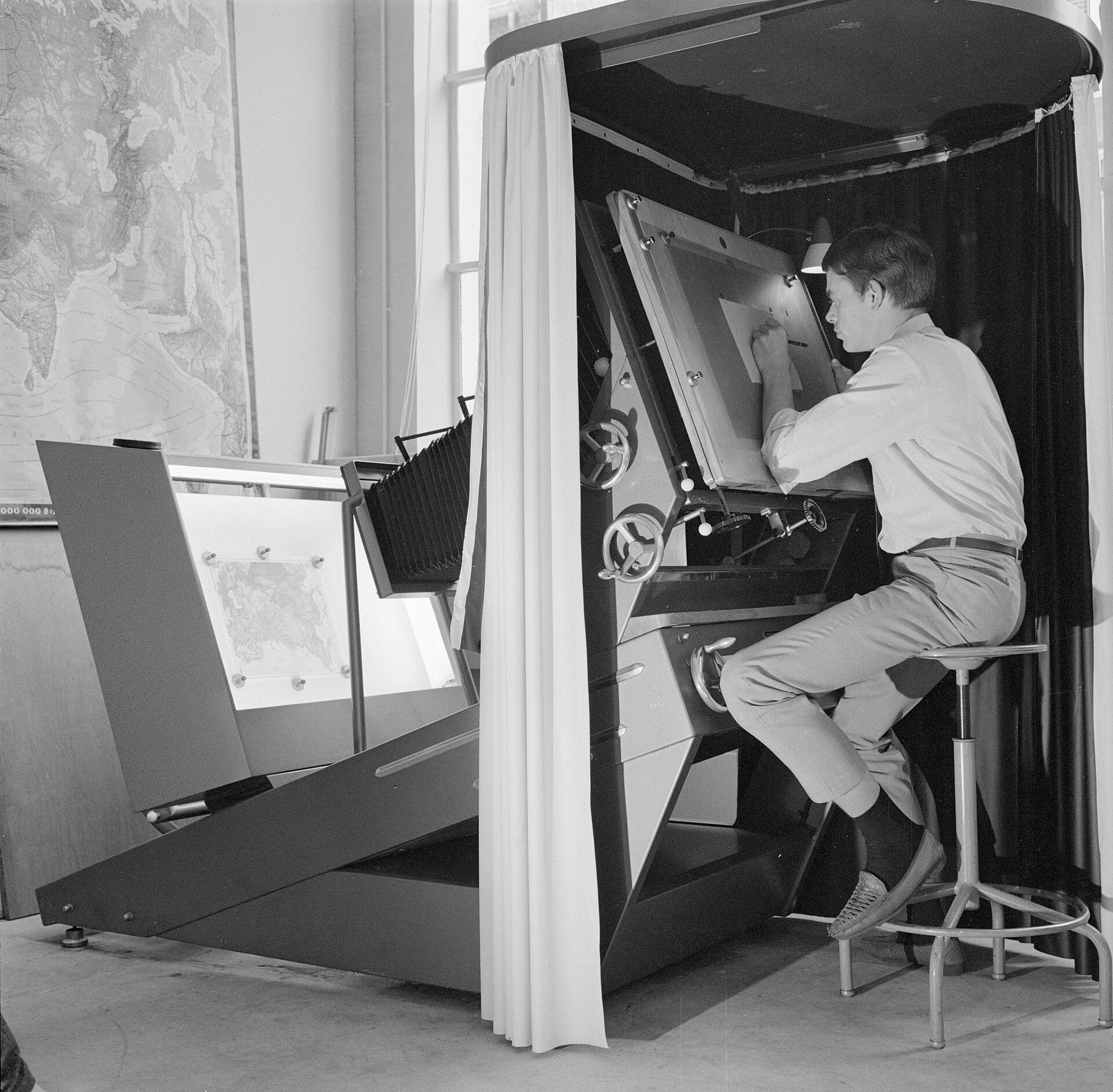 Een medewerker bezig met het reproduceren van een kaart, Bestanddeelnr 254-5200
