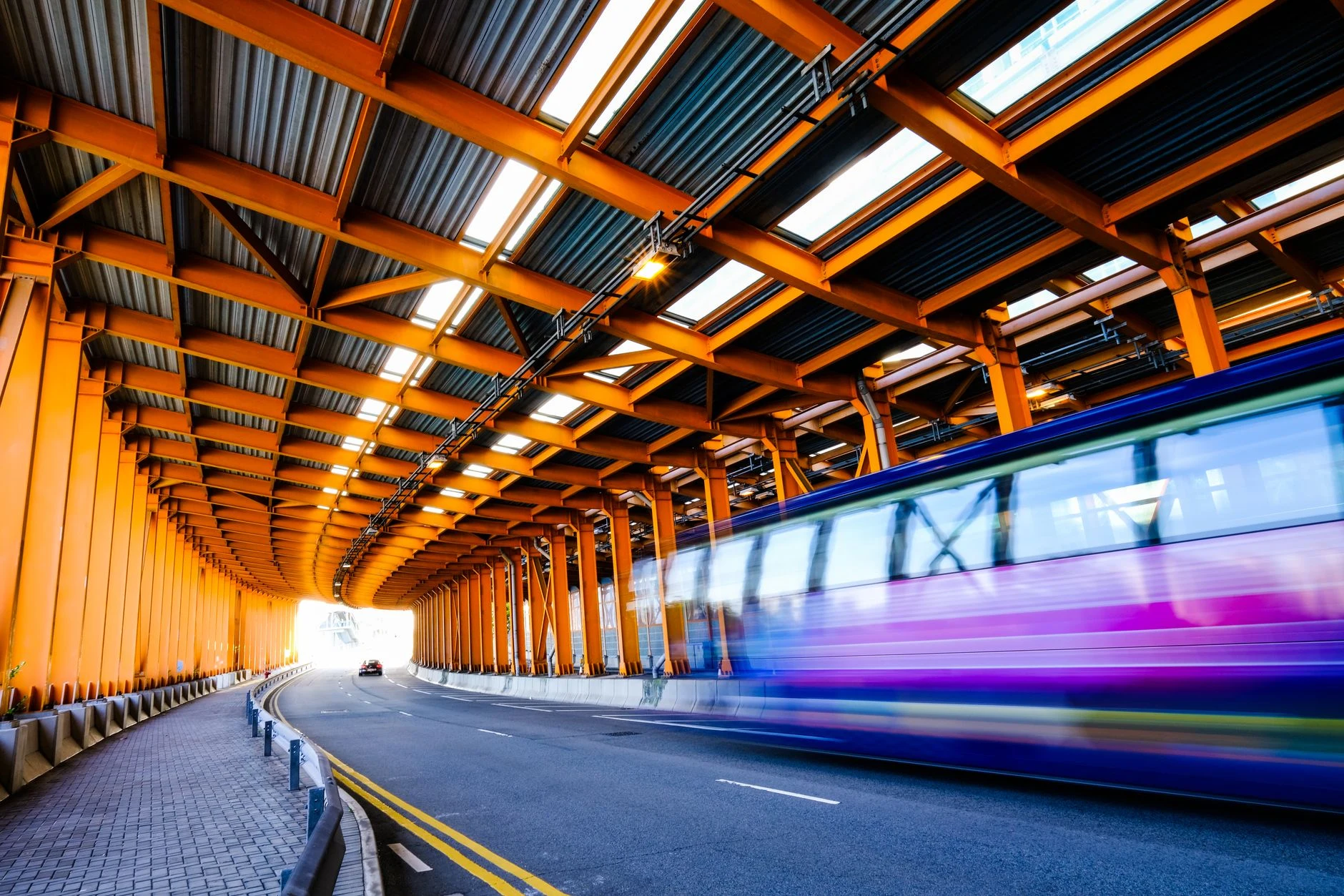 Dynamic scene of a vibrant city tunnel in Hong Kong with blurred motion effect.