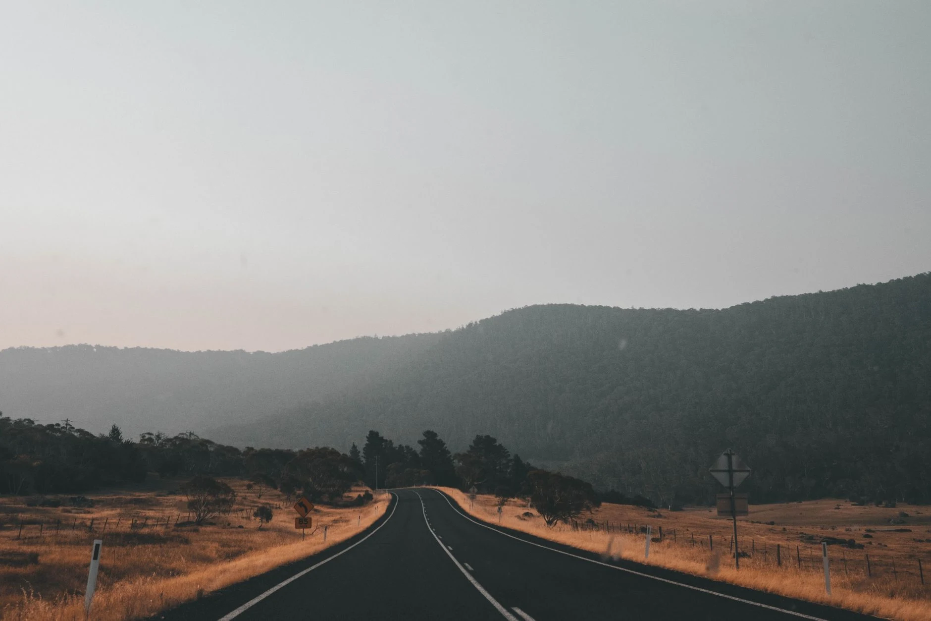 A tranquil road through scenic Australian countryside near Thredbo, NSW, perfect for road trips.