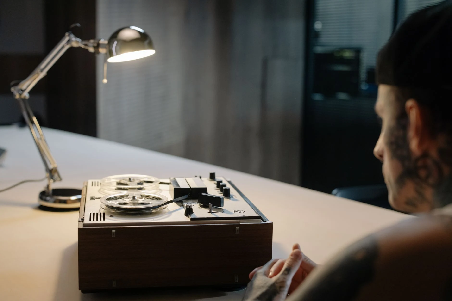 Moody interrogation room setup with a vintage tape recorder and dim lighting.