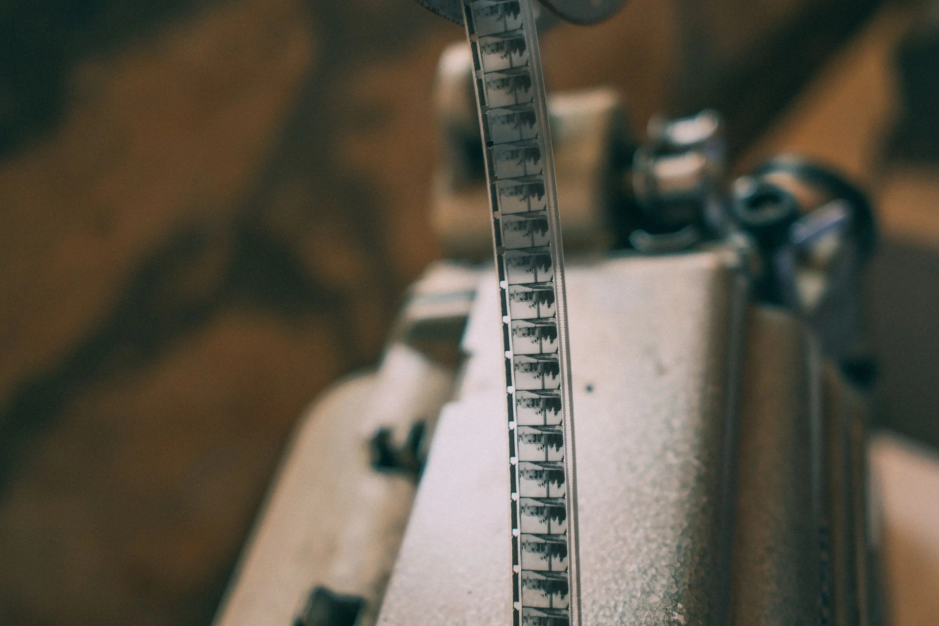 Close-up of a vintage film strip on a projector, showcasing classic cinema.