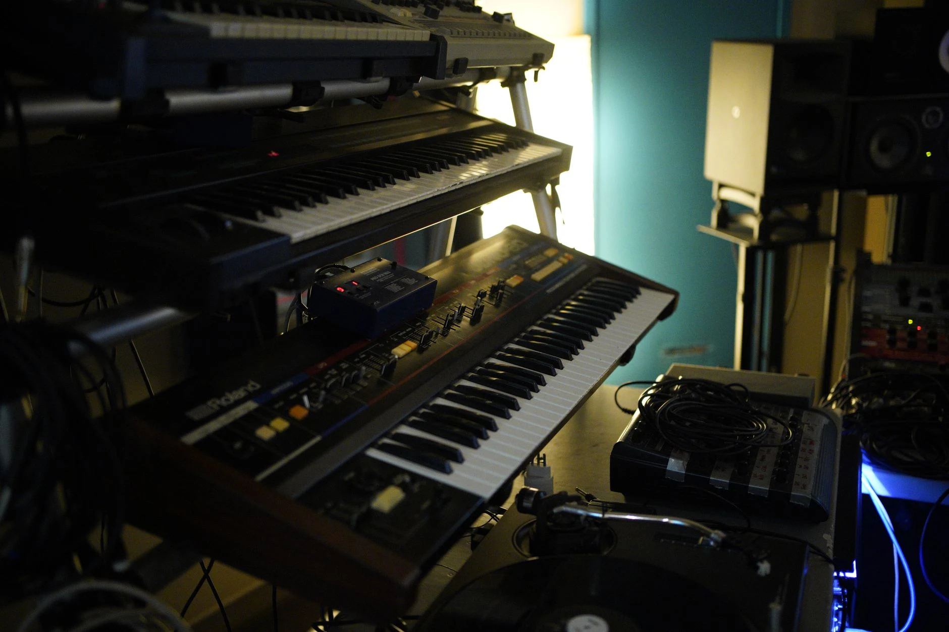 Close-up of vintage keyboard synthesizers in music studio setting, ideal for music production.